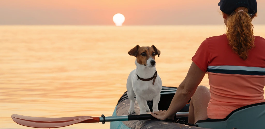 site middle banner-a dog with a woman in the inflatable kayak